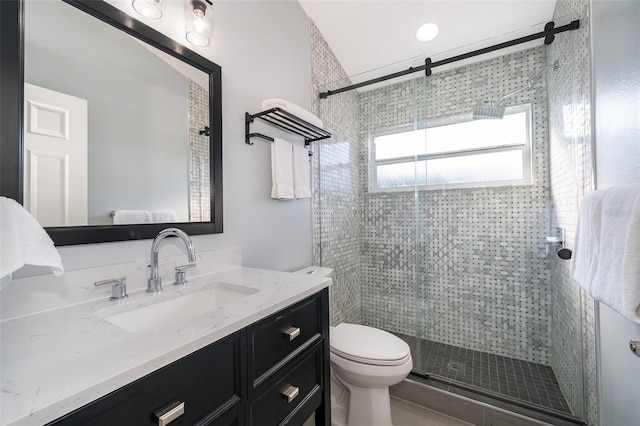 bathroom with vanity, toilet, and walk in shower