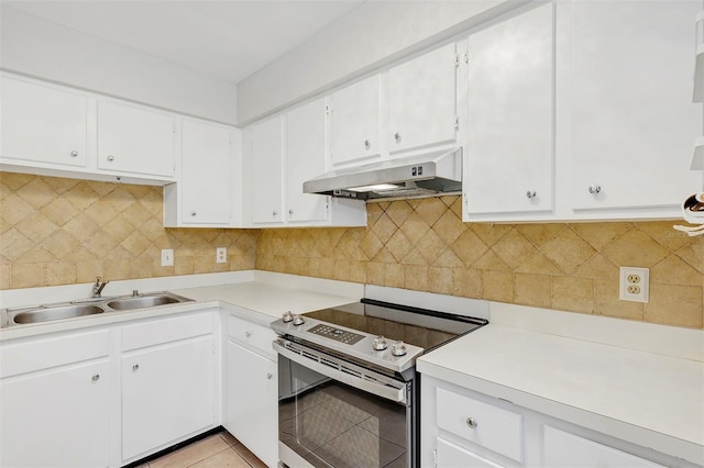 kitchen featuring under cabinet range hood, a sink, electric stove, light countertops, and backsplash