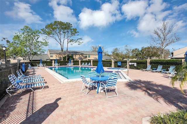 pool featuring fence and a patio