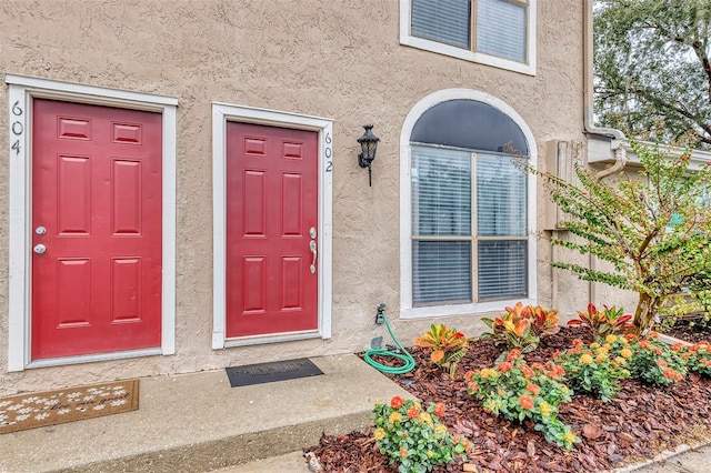 view of exterior entry featuring stucco siding