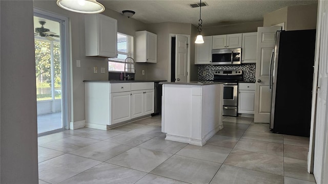 kitchen featuring white cabinetry, sink, pendant lighting, and stainless steel appliances