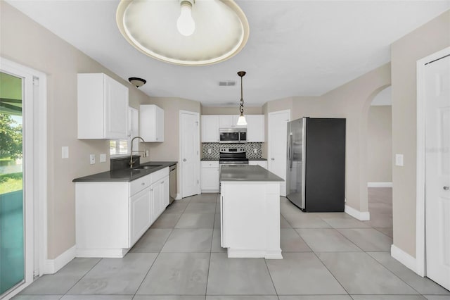 kitchen with sink, a center island, white cabinets, and appliances with stainless steel finishes