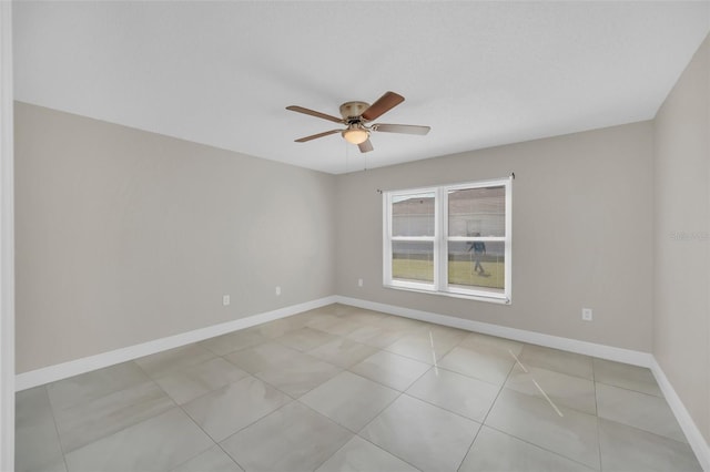 empty room featuring light tile patterned floors and ceiling fan