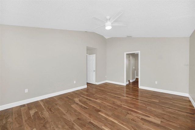 unfurnished room featuring lofted ceiling, dark hardwood / wood-style floors, a textured ceiling, and ceiling fan