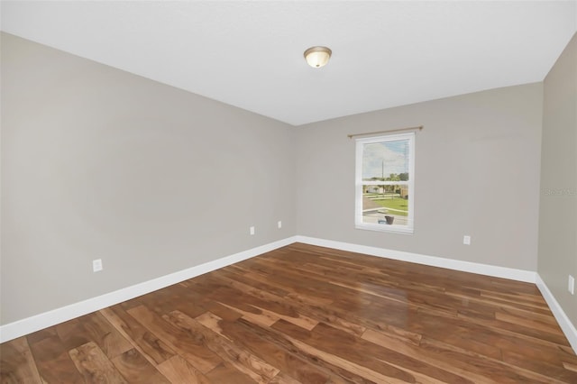 unfurnished room with hardwood / wood-style flooring