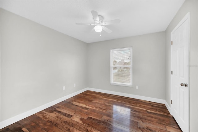 empty room featuring dark hardwood / wood-style flooring and ceiling fan