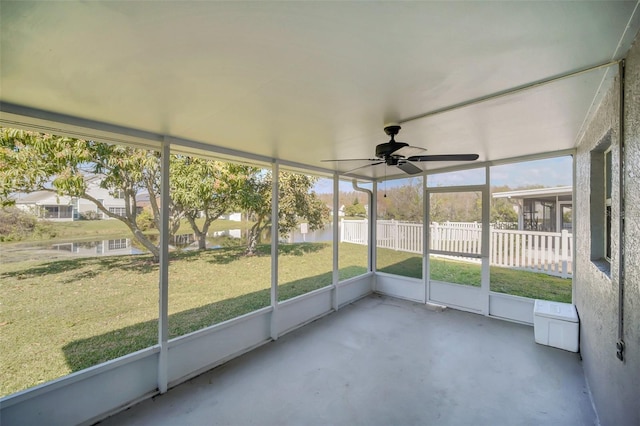 unfurnished sunroom featuring ceiling fan