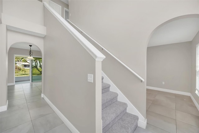 stairs with tile patterned floors