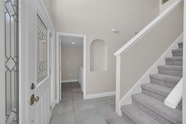 foyer entrance with light tile patterned floors