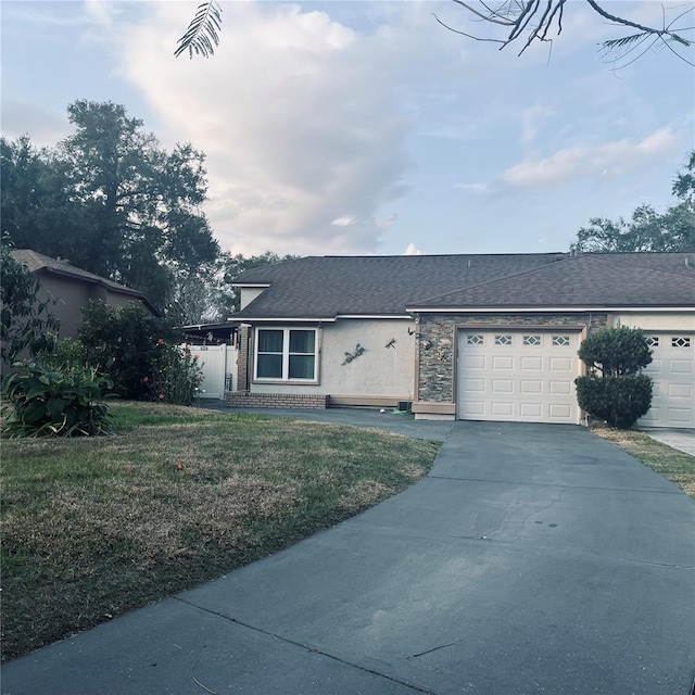 ranch-style house with a garage and a front lawn