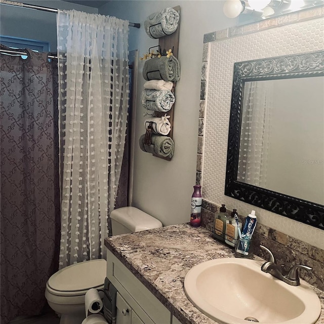 bathroom with vanity, toilet, and curtained shower