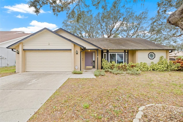 ranch-style home featuring a garage and a front lawn