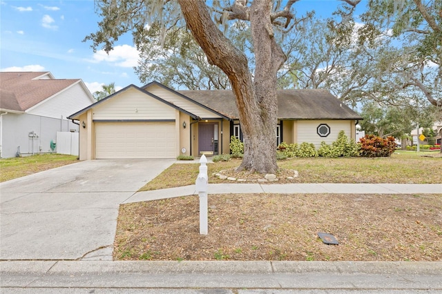 single story home with a garage and a front yard