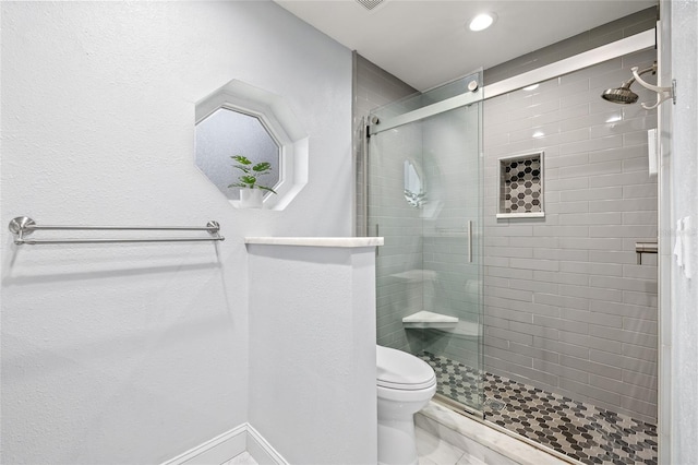 bathroom featuring toilet and walk in shower