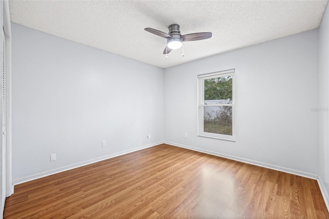 unfurnished room with ceiling fan, a textured ceiling, and light hardwood / wood-style floors