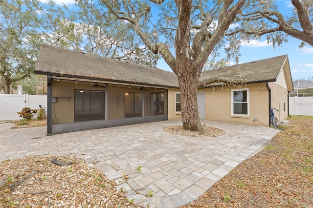 back of house with a sunroom and a patio