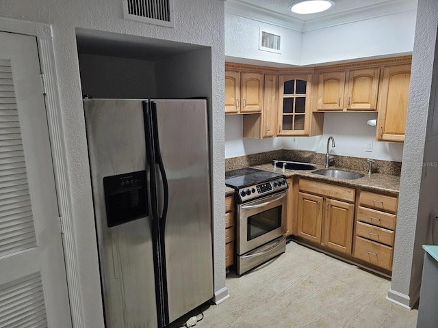 kitchen with stainless steel appliances, crown molding, and sink