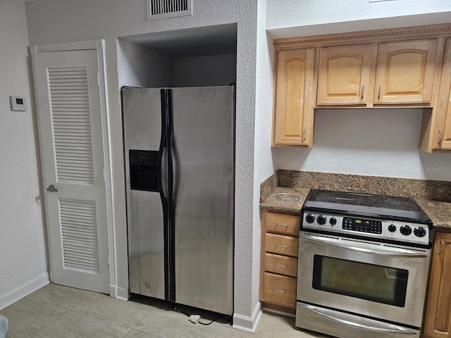 kitchen featuring appliances with stainless steel finishes and light tile patterned floors