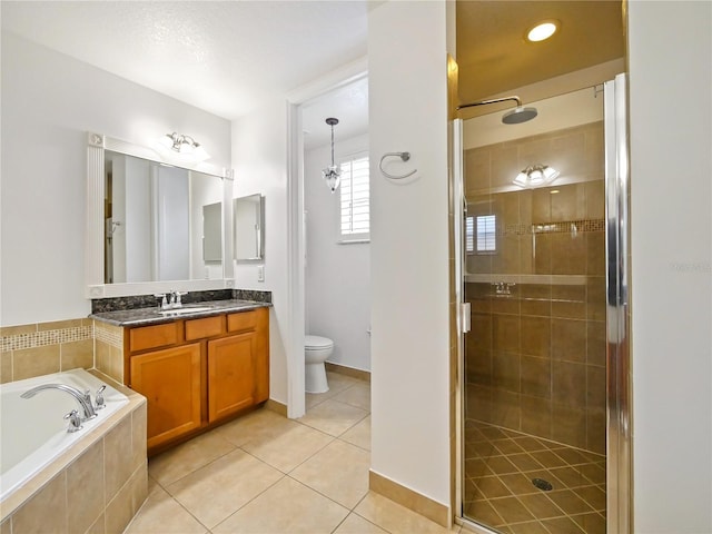 full bathroom featuring tile patterned floors, vanity, toilet, and shower with separate bathtub