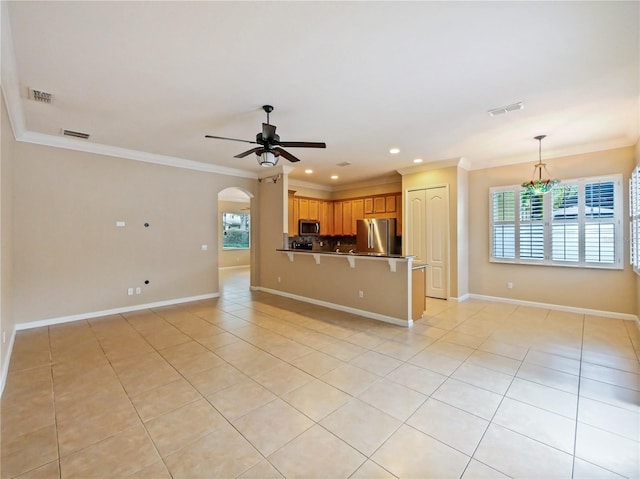 unfurnished living room featuring crown molding, ceiling fan, and light tile patterned floors