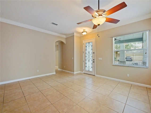 tiled foyer featuring crown molding and ceiling fan