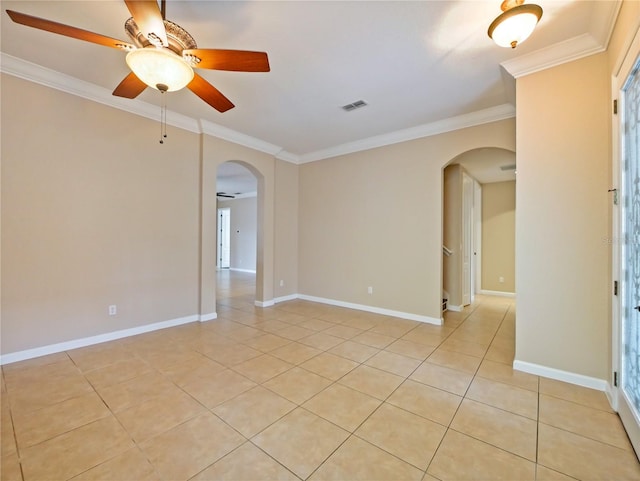 spare room with ceiling fan, ornamental molding, and light tile patterned floors