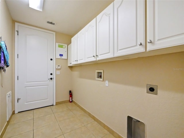 clothes washing area featuring cabinets, washer hookup, hookup for an electric dryer, and light tile patterned floors