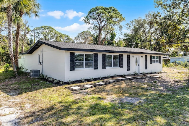 ranch-style home featuring a front yard and central AC unit