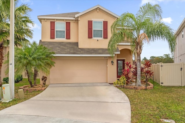 view of front of home featuring a garage and a front lawn