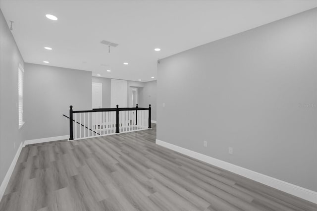 spare room with light hardwood / wood-style flooring