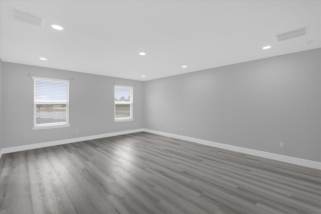 unfurnished room with dark hardwood / wood-style flooring