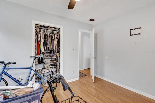 bedroom featuring wood-type flooring, a closet, and ceiling fan