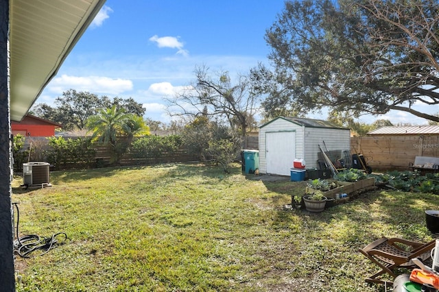 view of yard featuring a shed and central AC