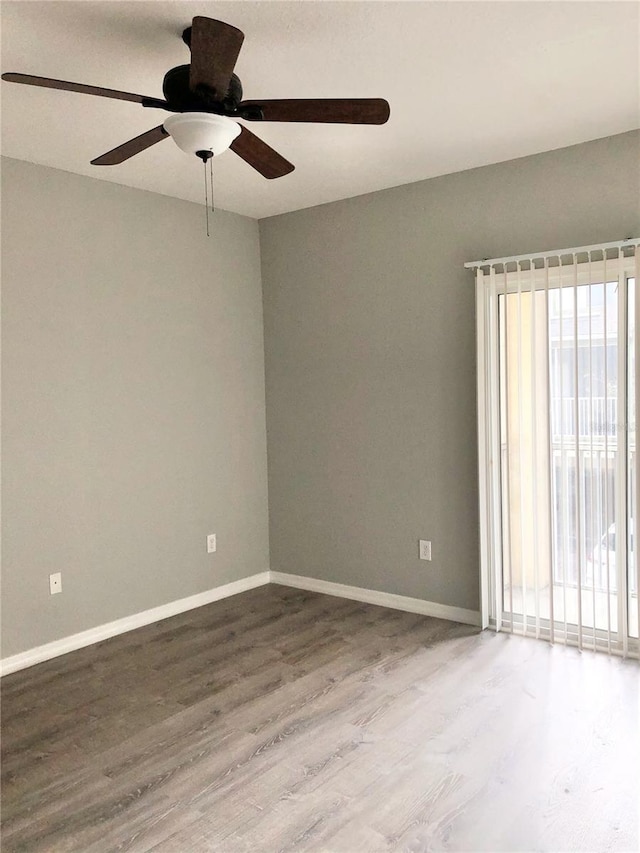 empty room featuring wood-type flooring and plenty of natural light