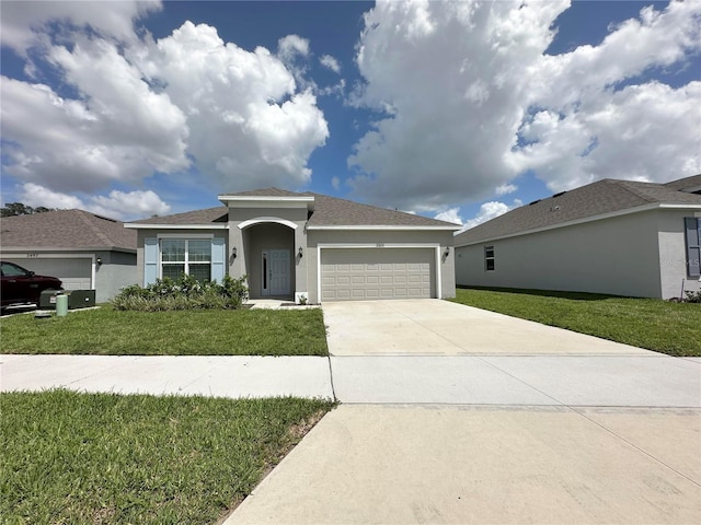 view of front of home with a garage and a front lawn