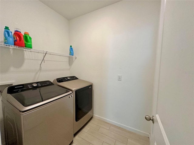 clothes washing area featuring washer and dryer