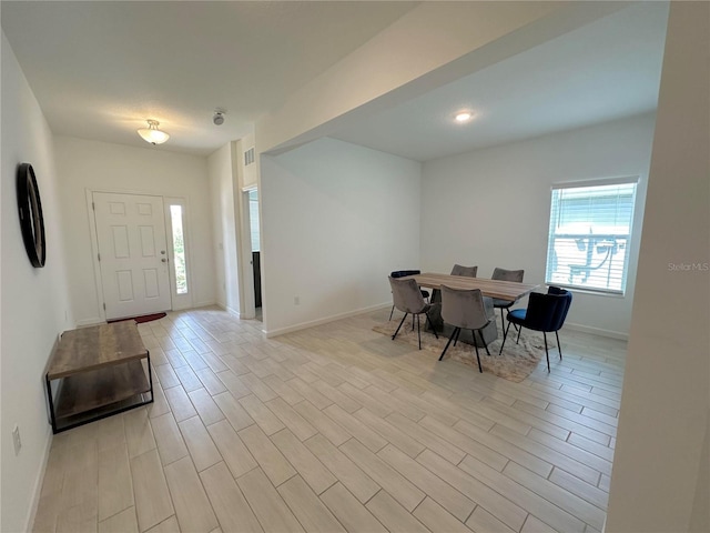 dining space with light hardwood / wood-style flooring