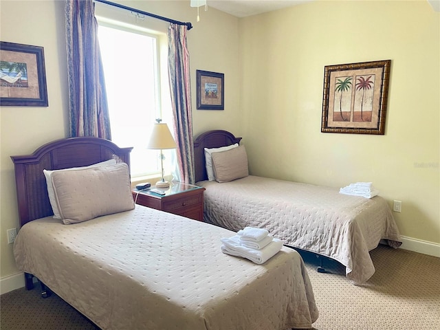 carpeted bedroom featuring multiple windows