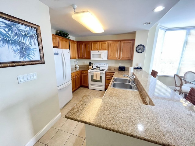 kitchen featuring sink, white appliances, kitchen peninsula, and light tile patterned floors