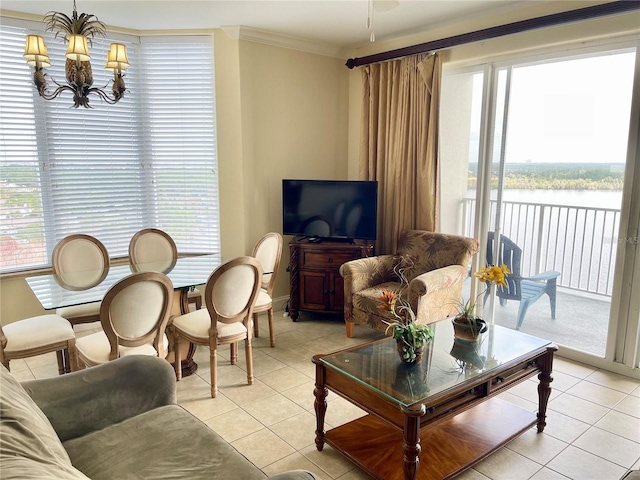 tiled living room featuring crown molding, a healthy amount of sunlight, and a notable chandelier