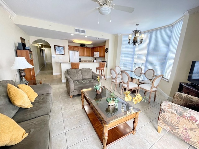 living room with ceiling fan with notable chandelier and light tile patterned floors