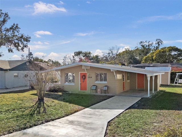 ranch-style house featuring a front yard and a carport