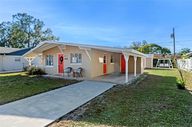 single story home featuring a carport and a front yard