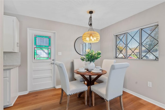 dining area with a chandelier and light wood-type flooring