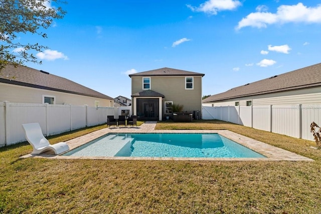 view of swimming pool with a yard