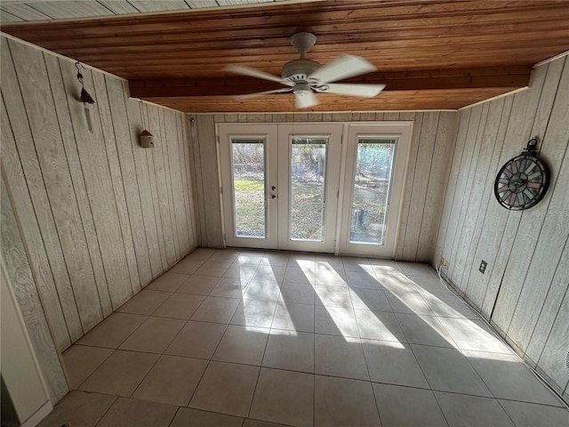 interior space with light tile patterned floors, wooden ceiling, french doors, and ceiling fan