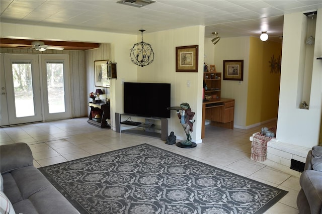 423 Longfellow Blvd, Lakeland, FL 33801 - living room with light tile patterned floors, a ceiling fan, baseboards, and wooden walls