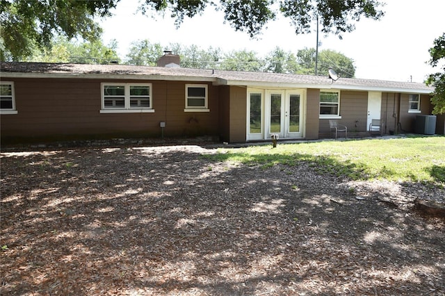 423 Longfellow Blvd, Lakeland, FL 33801 - back of house featuring a chimney, cooling unit, and french doors