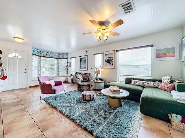 tiled living room featuring ceiling fan