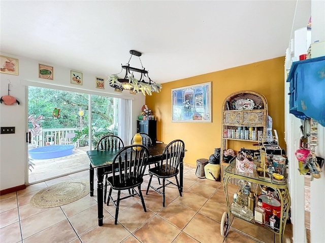 tiled dining area with a notable chandelier